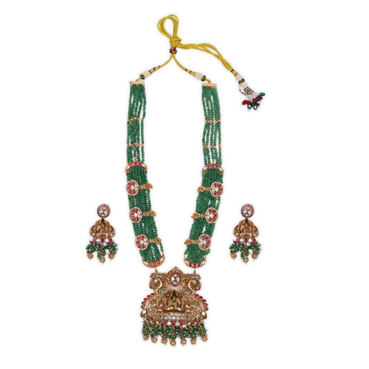 Matte Gold Polish Long Rajwadi Necklace Set with Crown-Shaped Doli Bride Pendant, Intricately Detailed with Ruby Stones, Kundan, and Bandai Work to Enhance Its Grandeur