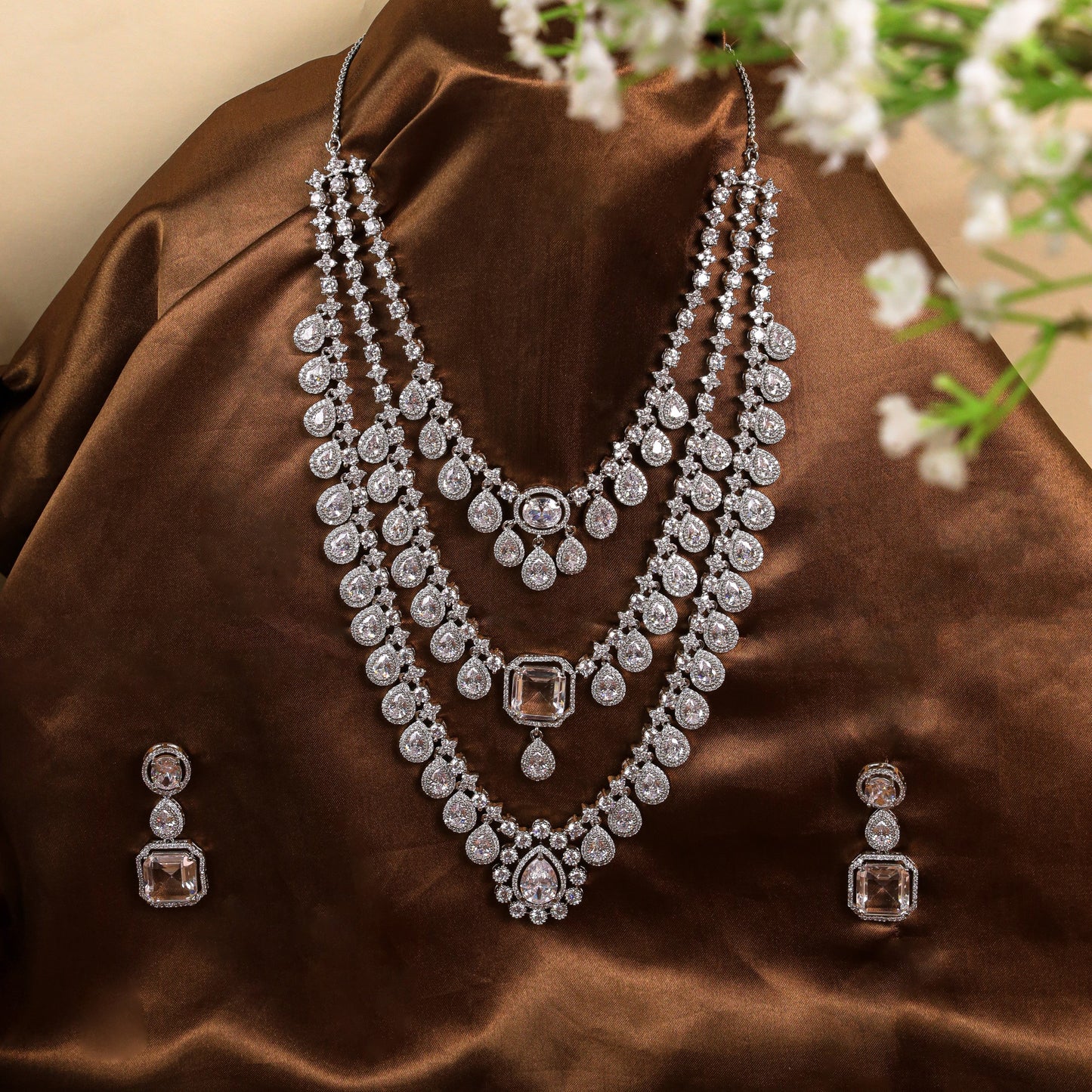 Graceful V-Shaped Design: Long 3-Line AD Necklace with American Diamonds and Pear-Shaped Stone at the Heart, Crafted in Brass Metal