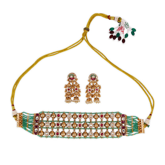 Antique Gold Polish Rajwadi Choker Set Studded with Dazzling Ruby and Kundan Stones, Enhanced by Lush Green Beads for a Regal and Rich Appeal