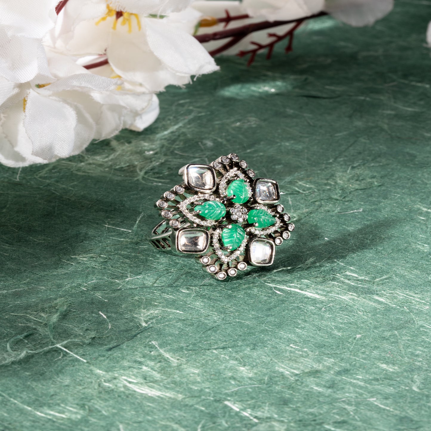 Floral-inspired design with carved green leaf-shaped stones at the center, Kundan, AD