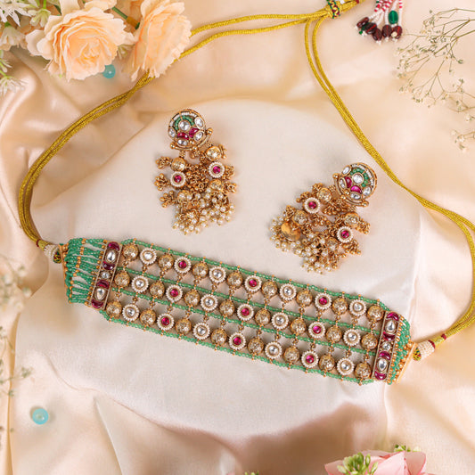Antique Gold Polish Rajwadi Choker Set Studded with Dazzling Ruby and Kundan Stones, Enhanced by Lush Green Beads for a Regal and Rich Appeal